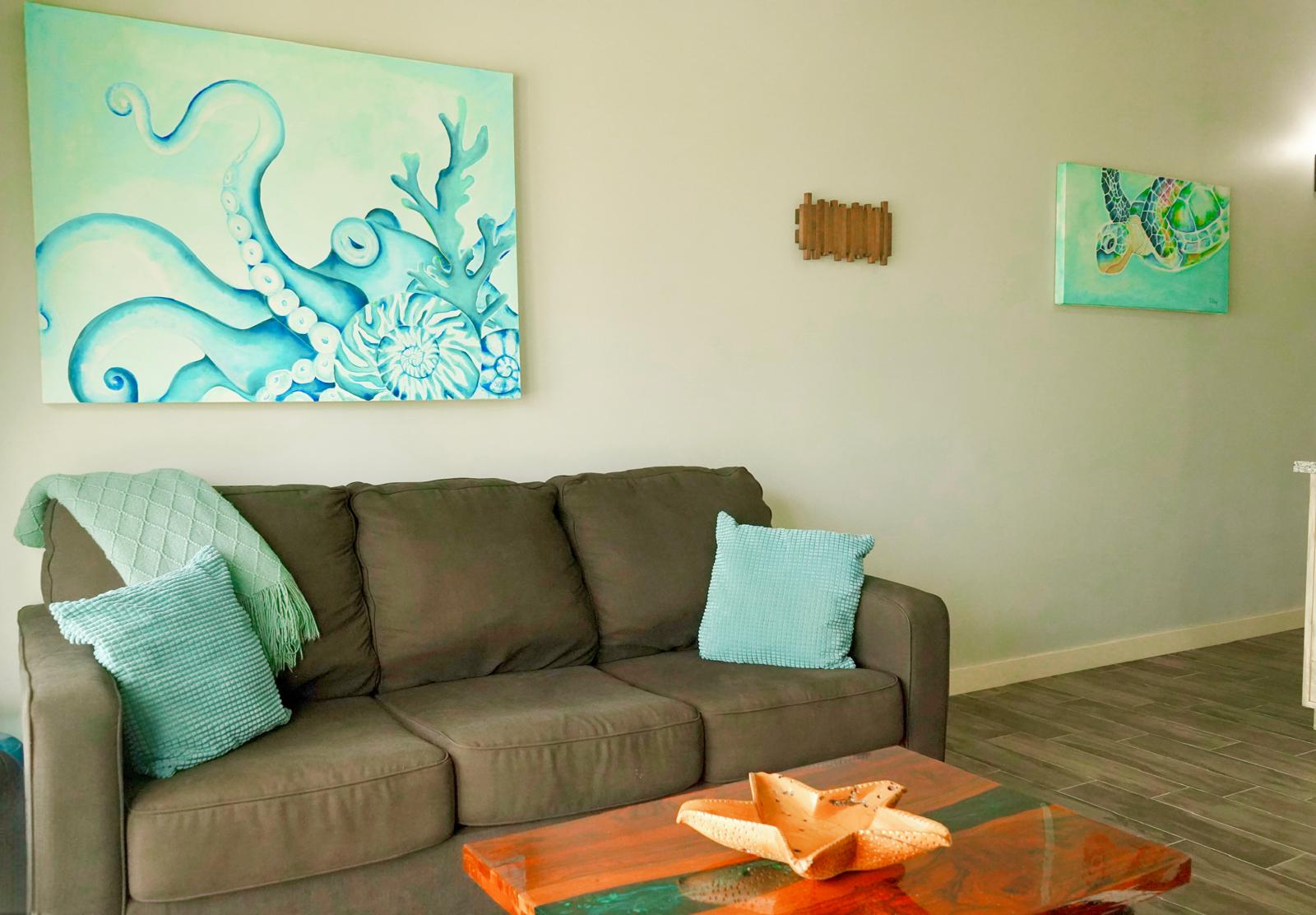 Villa living area with couch, pillows, and blanket