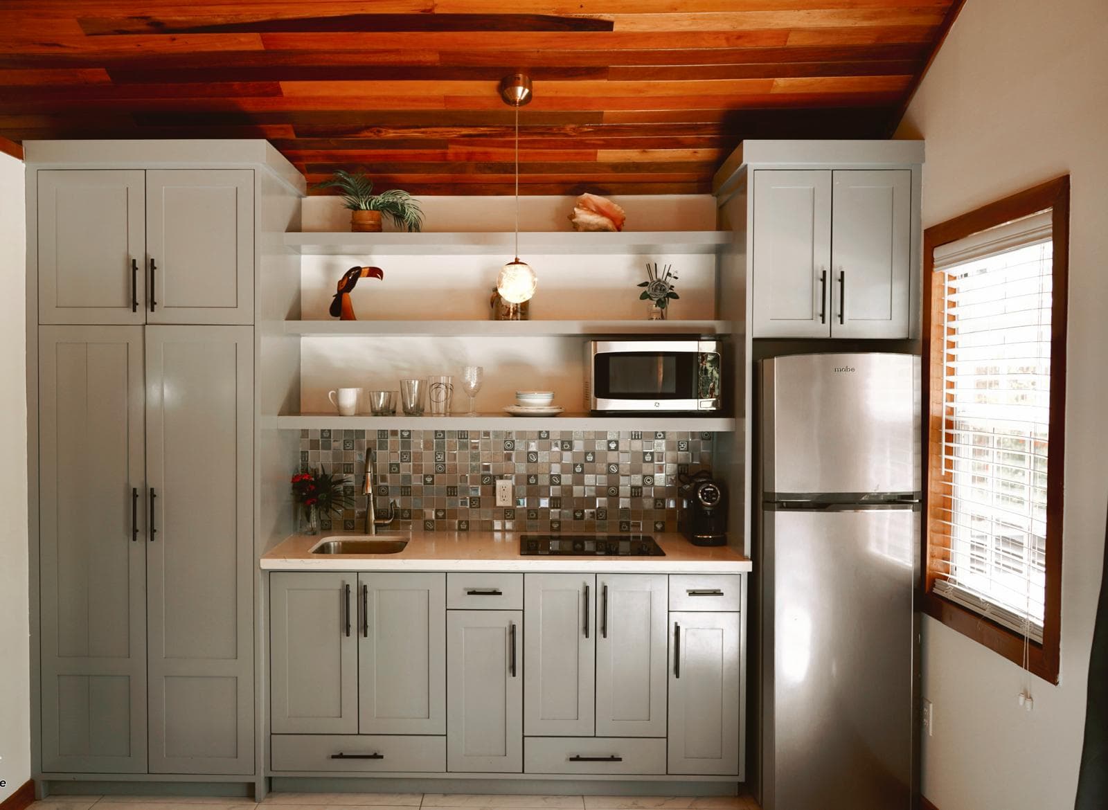 Casita kitchen with refrigerator, microwave, and cooktop