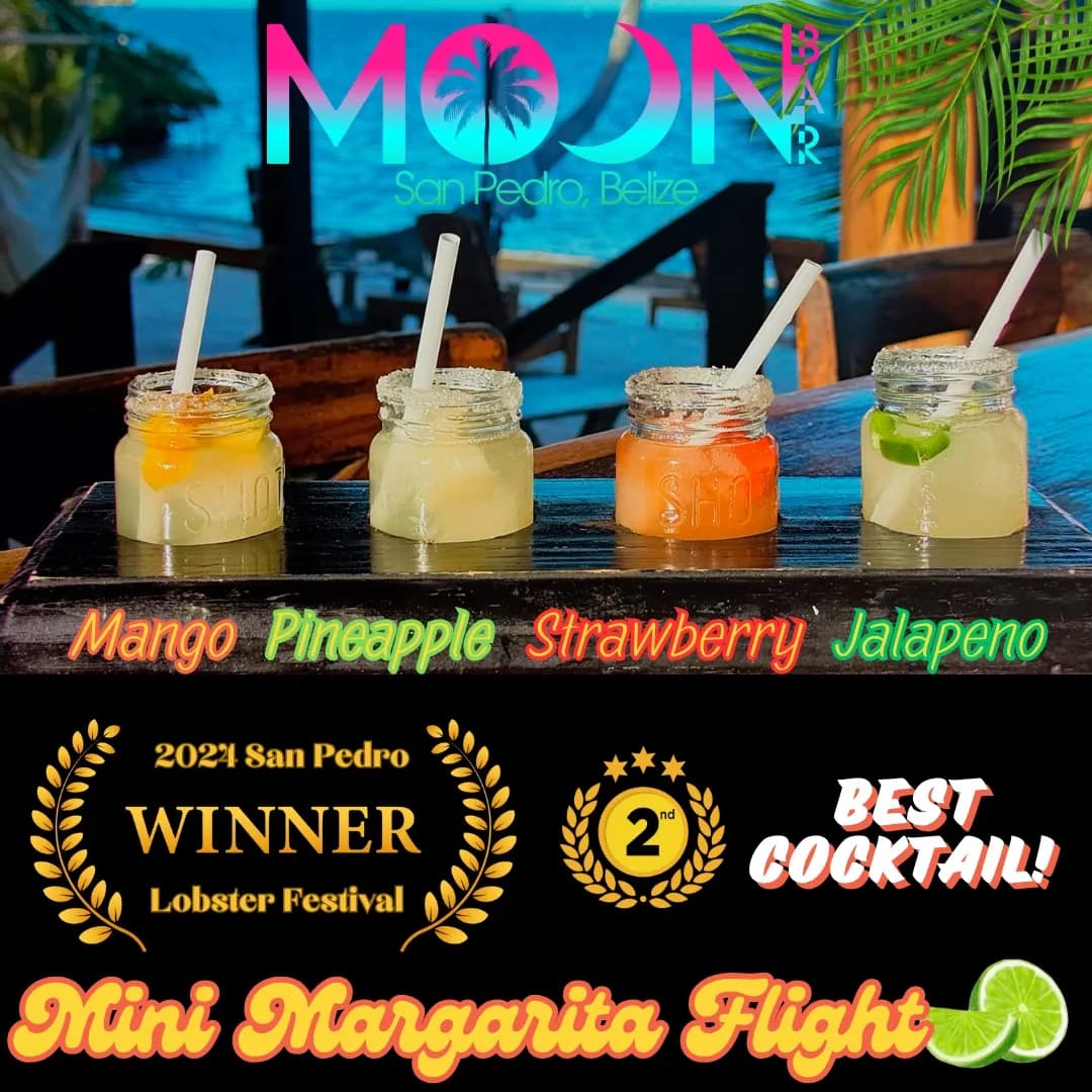Four mini margarita cocktails in jars, featuring mango, pineapple, strawberry, and jalapeno flavors, showcased at Moon Bar in San Pedro, Belize.