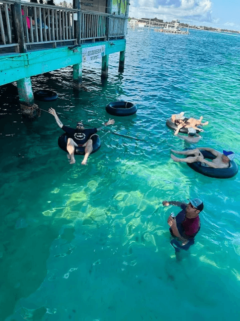 Adults floating in round inner Tubes at Palapa Bar
